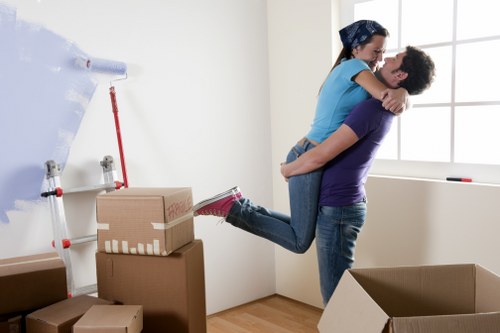 Professional flat removal team handling furniture in Plumstead